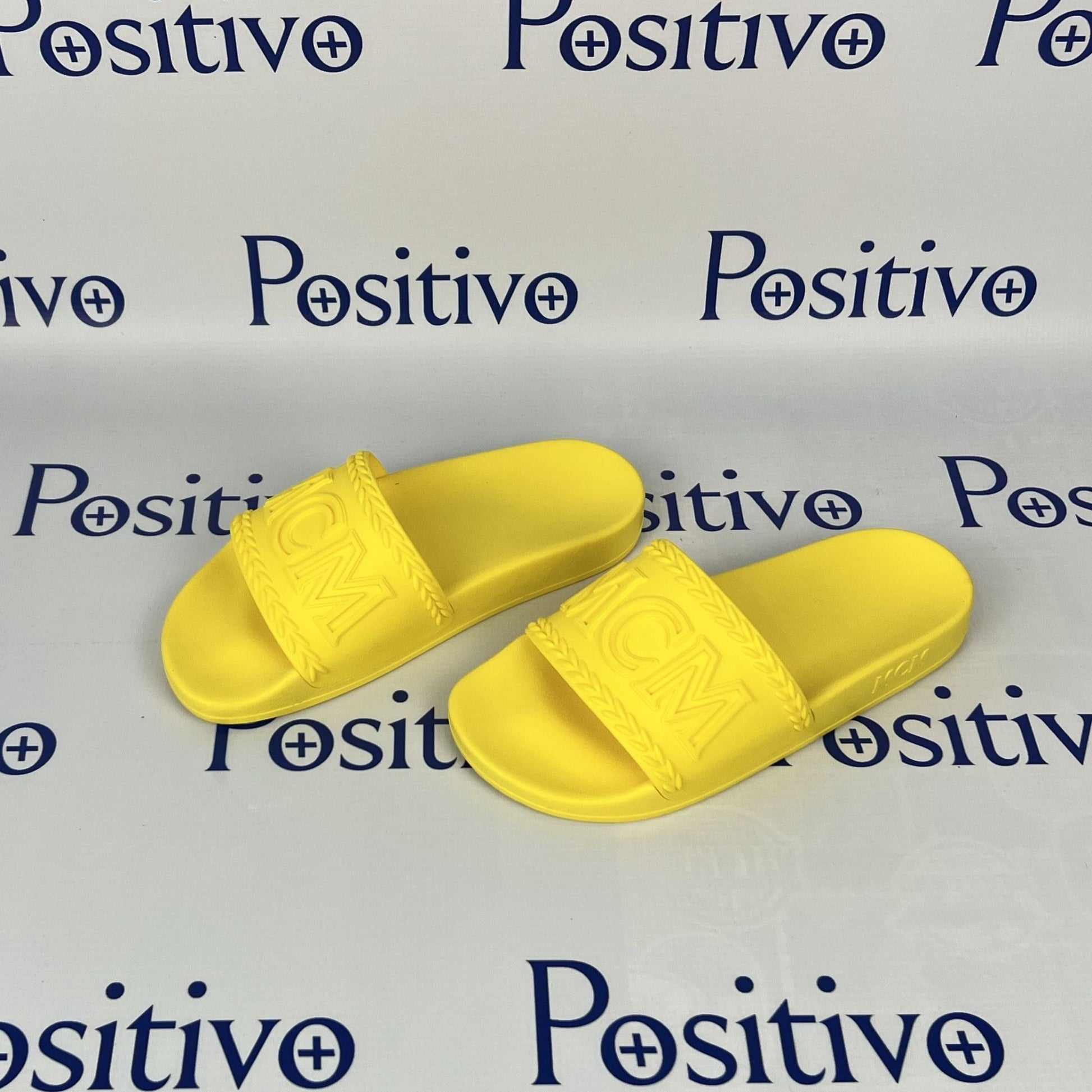 MCM Womens Yellow Big Logo Rubber Slides | Positivo Clothing