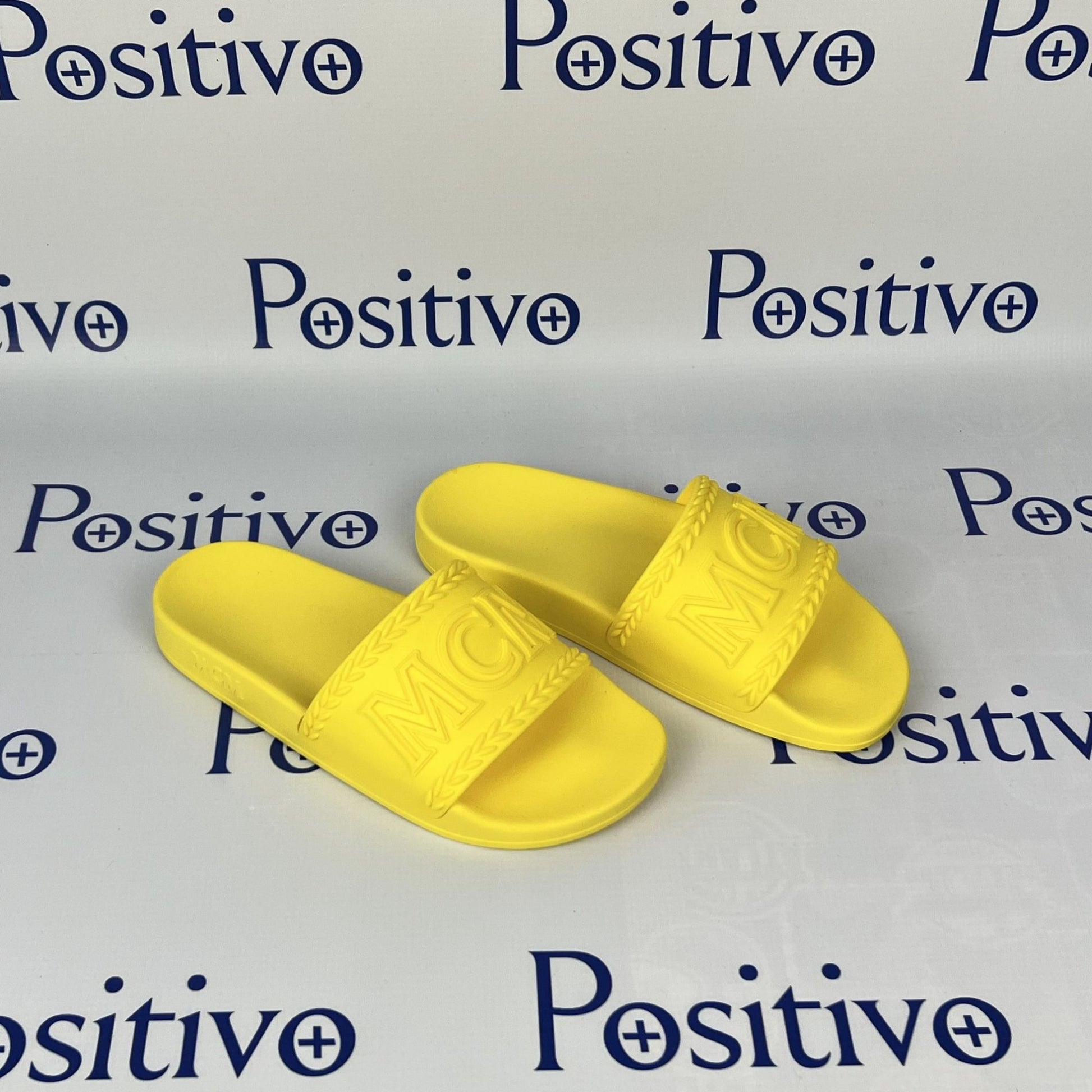 MCM Womens Yellow Big Logo Rubber Slides | Positivo Clothing