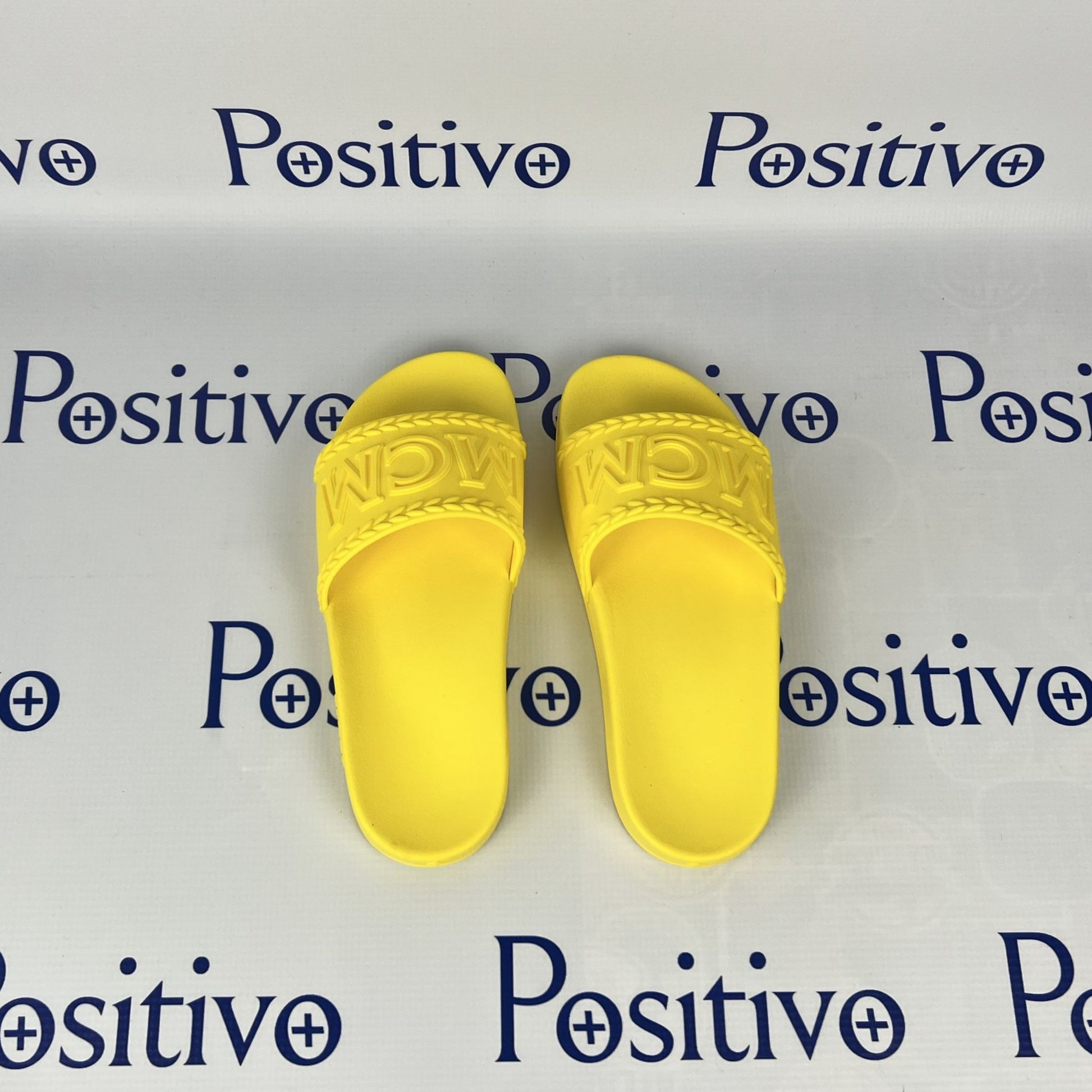 MCM Womens Yellow Big Logo Rubber Slides | Positivo Clothing