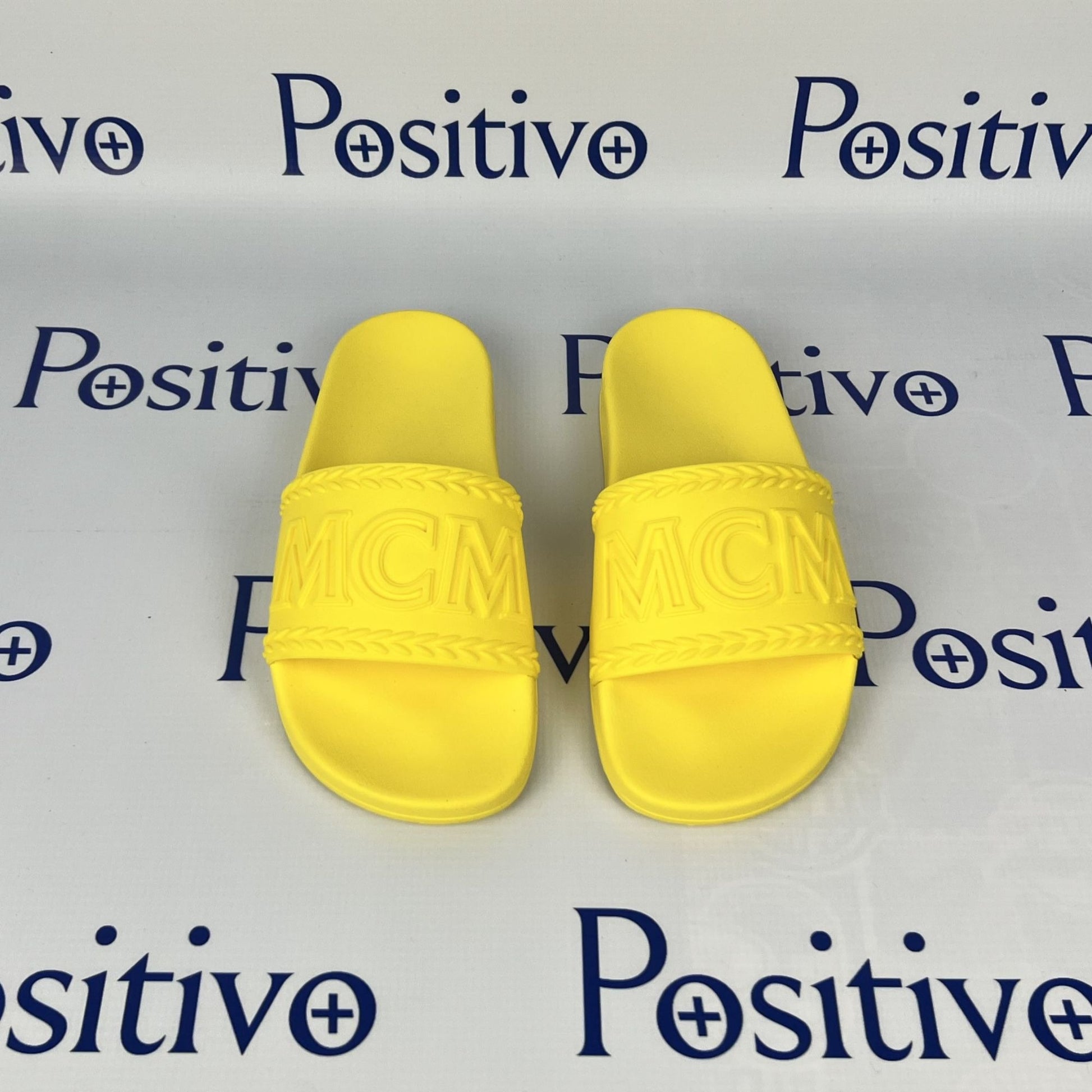 MCM Womens Yellow Big Logo Rubber Slides | Positivo Clothing