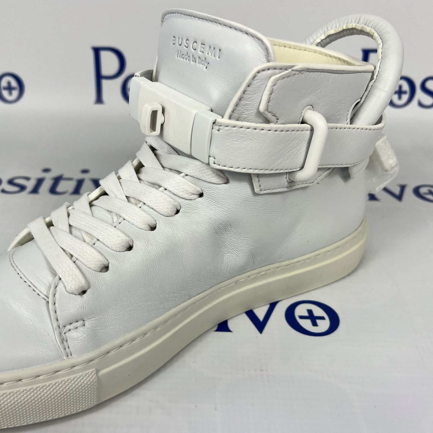 Buscemi Womens 100MM Flat Tonal White Leather Sneakers | Positivo Clothing